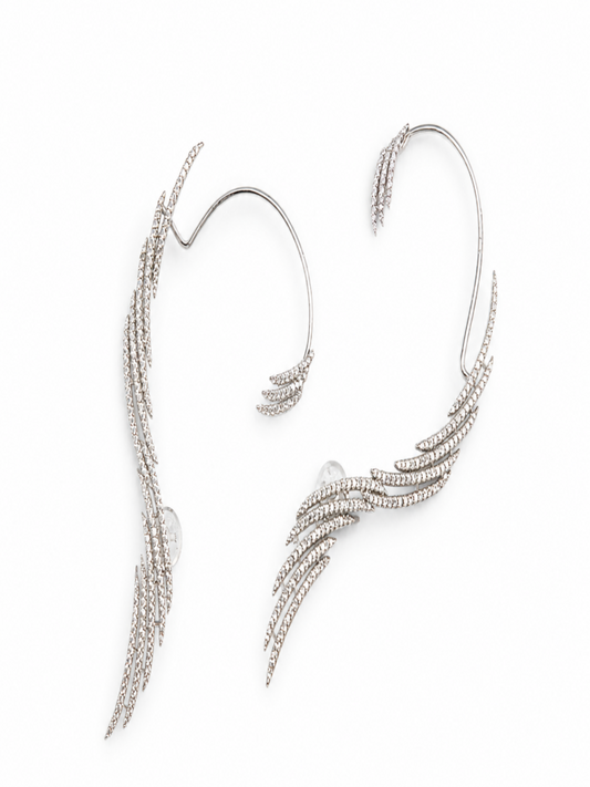 A pair of silver-toned ear cuffs decorated with delicate, feather-like textured bands set with small clear rhinestones, displayed on a clean white background.