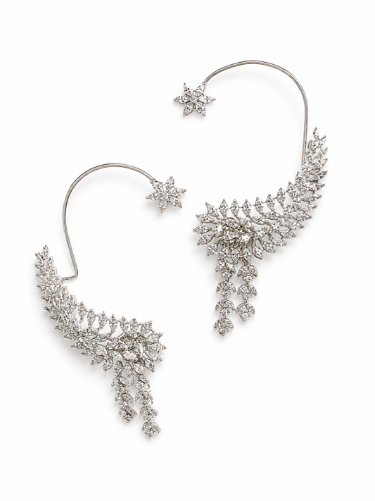 A pair of silver-toned ear cuffs decorated with sparkling clear crystals in a leaf and starburst pattern, shown on a clean white background.