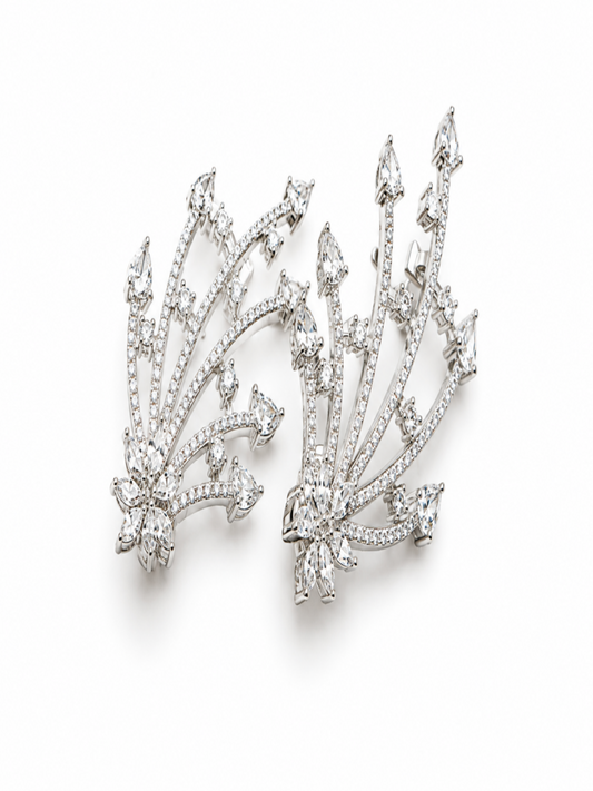 A pair of silver-toned diamond cluster earrings with a fanburst design, photographed on a clean white background.
