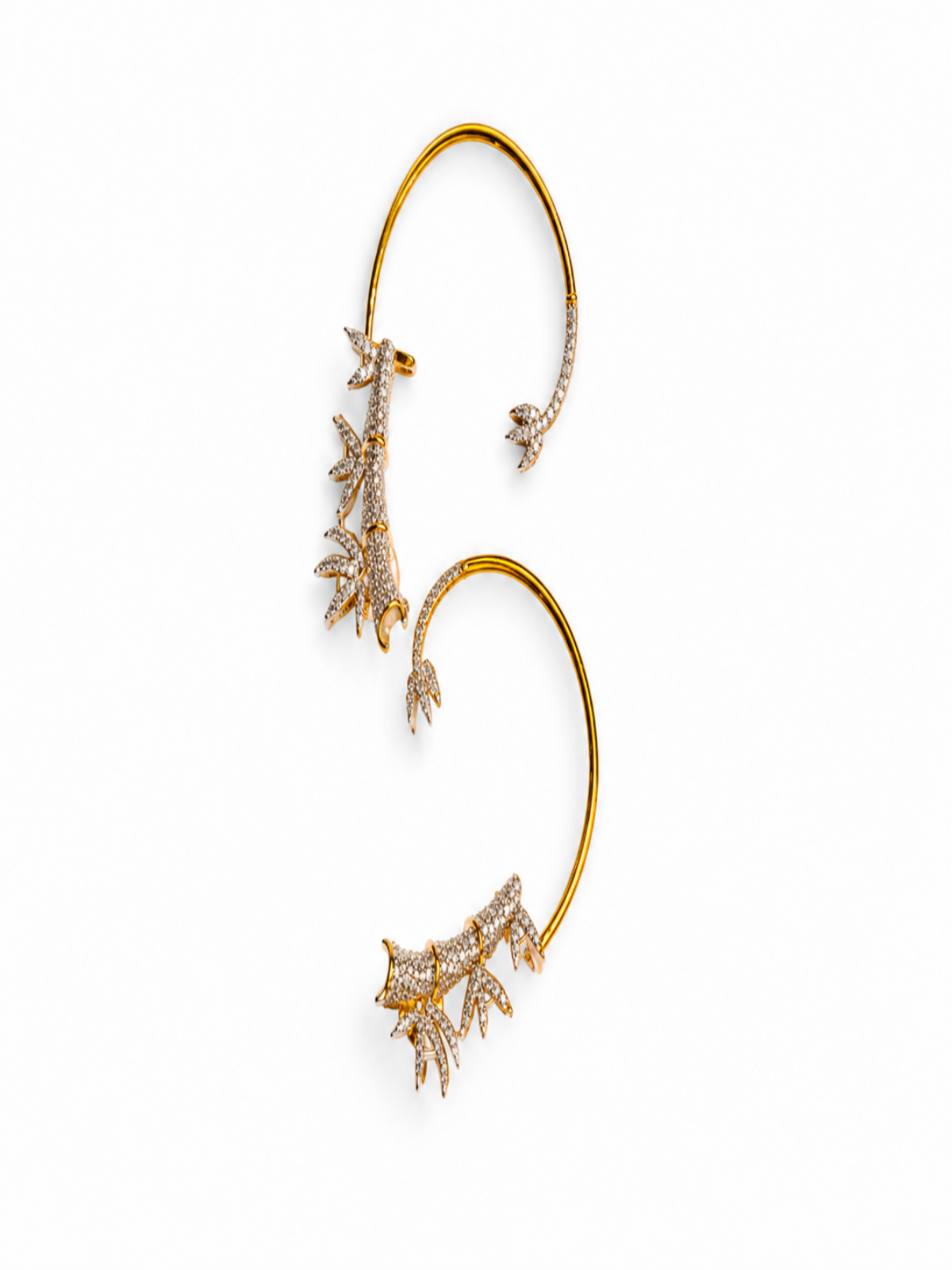A pair of gold ear cuffs decorated with delicate coral-like clusters of clear pavé stones, displayed on a clean white background.