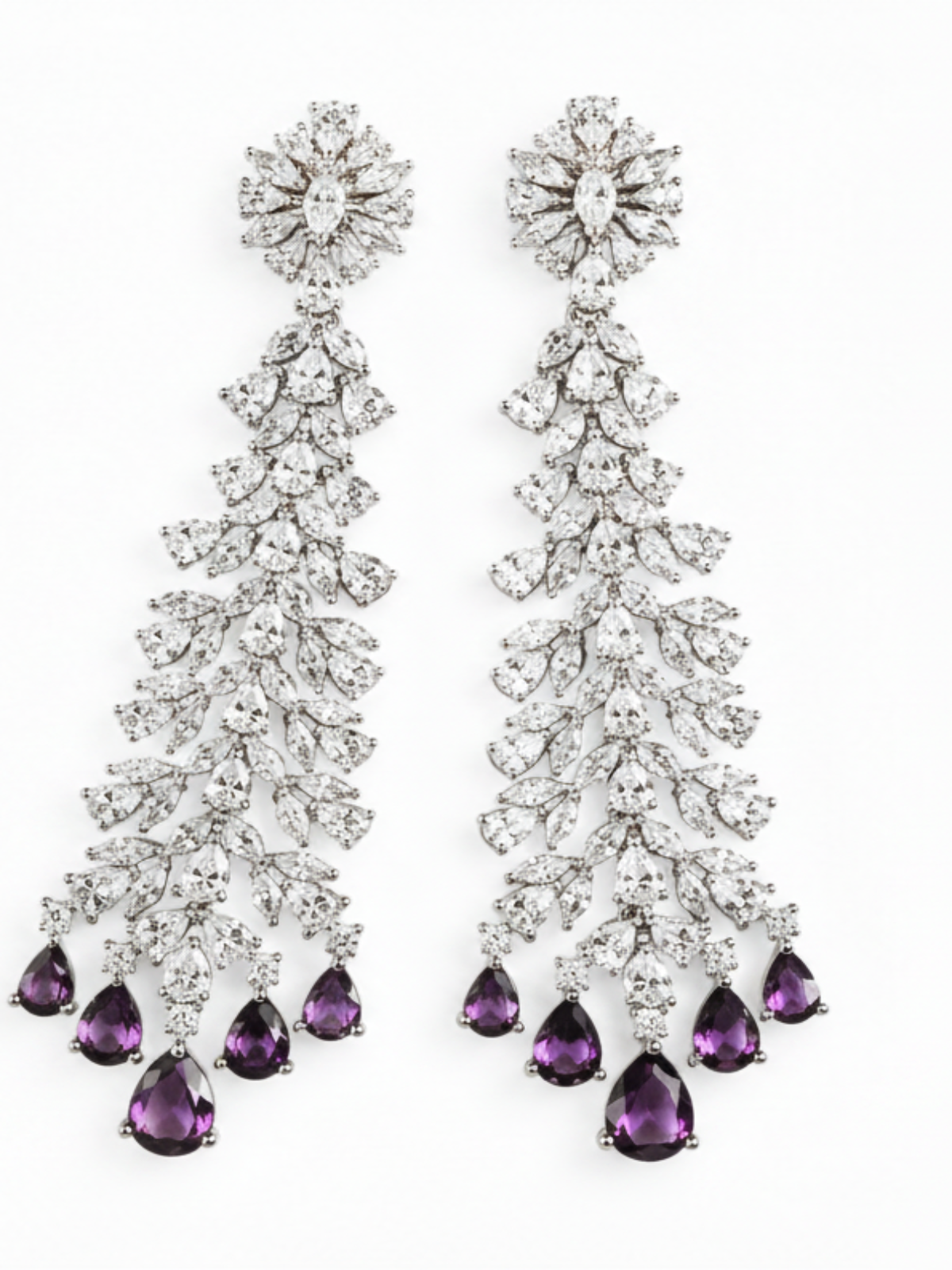 A pair of long chandelier drop earrings with clear faceted stones in a silver-toned setting, each ending in five black teardrop-shaped stones, shown on a plain white background.