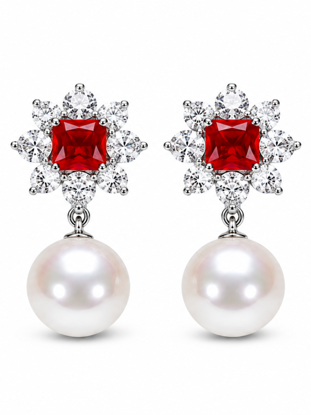 A pair of drop earrings featuring a square-cut red gemstone surrounded by small clear stones in a floral burst, with a large white pearl dangling below, set against a plain white background.