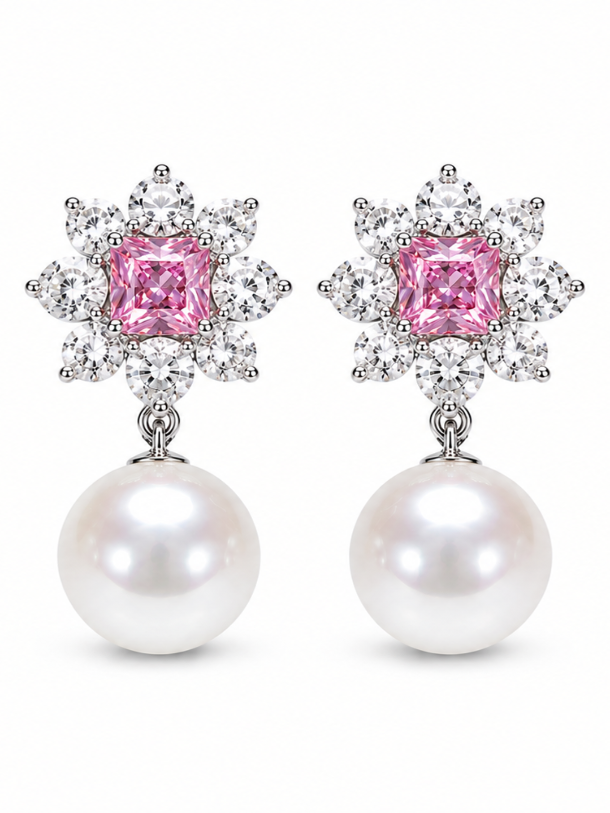 A pair of drop earrings featuring a central pink cushion-cut gemstone surrounded by a halo of small clear stones, with a large white pearl dangling below, set against a plain white background.